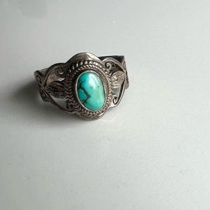 Silver ring with turquoise stone and intricate detailing